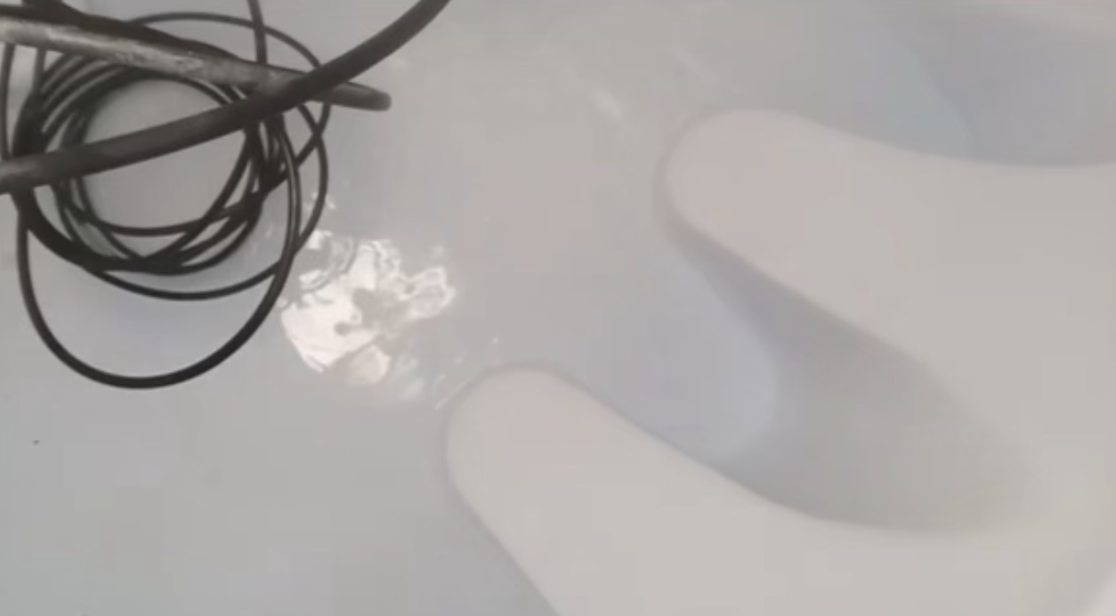 Clean water tank after professional disinfection showing pristine white interior